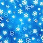Blue blurred background with glowing snowflakes. Vector festive background. Abstract winter background.