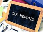 Tax Refund Concept Hand Drawn on Chalkboard on Working Table Background. Blurred Background. Toned Image. 3D Render.