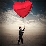 Man holds a big red heart balloon