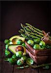 Assortment of fresh green vegetables on wooden table