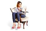 Young woman sitting on an old school chair with tablet reading and watching e-mails.