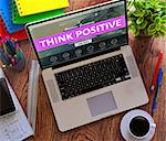 Think Positive Concept. Modern Laptop and Different Office Supply on Wooden Desktop background. 3D Render.