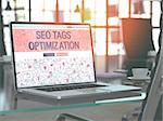 SEO Tags Optimization - Closeup Landing Page in Doodle Design Style on Laptop Screen. On Background of Comfortable Working Place in Modern Office. Toned, Blurred Image. 3D Render.