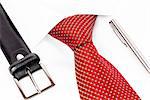 red tie knotted double Windsor, leather belt and silver pen