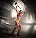 Woman is training with barbell at gym
