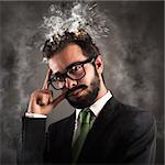 Stressed businessman with his head in smoke