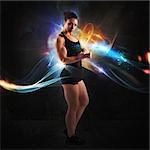 Muscular woman with colorful light effects background