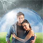 Smiling couple sheltered by a transparent ball