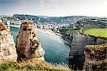 View from the famous white cliffs of Étretat on the beach and the village, Alabaster Coast, Normandy, France