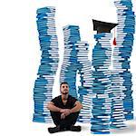 Boy sitting between stacks of study books