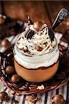 Delicious dessert - chocolate mousse decorated with whipped cream in a glass jar