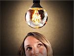 Big light bulb shining over a businesswoman