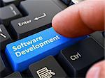 Software Development - Written on Blue Keyboard Key. Male Hand Presses Button on Black PC Keyboard. Closeup View. Blurred Background. 3D Render.
