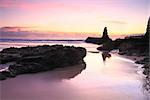 Beautiful sunrise skies and reflected colours in the tidal wet sands.  Jones Beach, Kiama Downs Australia