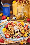 Belgian pumpkin waffles with fresh strawberry, kumquat, honey and cup of coffee