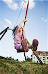 5 year old girl playing with a zip line on a sunny evening, Germany