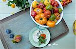 Overhead View of Bowl of Heirloom Tomatoes and Plate of Feta Cheese and Fresh Basil