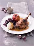 Goose leg with a baked apple, red cabbage and a potato dumpling