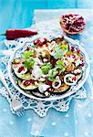 Courgette salad with feta cheese and pomegranate seeds