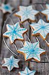Gingerbread star biscuits decorated with blue and white icing