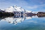 Piz da la Margna is reflected in the clear water of Lake Sils, Maloja Pass, Engadine, Canton of Graubunden, Switzerland, Europe