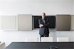 Portrait confident senior businessman in conference room