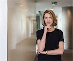 Portrait confident businesswoman in office corridor