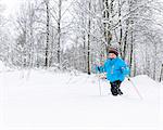 Young boy walking on snow