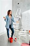 Young woman standing with painting brush