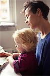 Mother with baby girl reading book