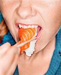 Woman eating sushi