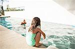 Toddler girl at edge of swimming pool