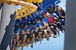 Young man screaming on amusement park ride