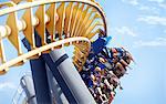 People riding amusement park ride