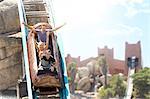 Enthusiastic friends cheering and riding log amusement park ride