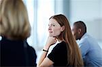 Confident businesswoman listening in meeting