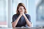 Pensive businesswoman looking away in conference room