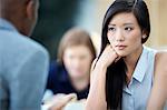 Serious businesswoman listening to businessman