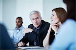 Senior businessman listening in meeting