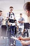 Smiling man with forearm crutches in physical therapy