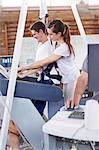 Physical therapist guiding man on treadmill