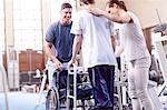 Physical therapists helping man with walker