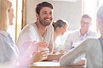 Smiling man with friends at cafe