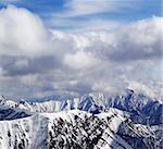 Winter snowy mountains and cloudy sky. Caucasus Mountains, Georgia, view from ski resort Gudauri.