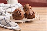 Baked chocolate muffins cooling off on wire mesh