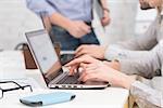 Close-up portrait of business people using laptop computers in office. Internet technologies and business projects concepts.