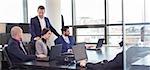 Workplace in modern office with business people brainstorming. Businessman working on laptop during the meeting.