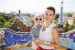 Barcelona will show you how to remarkably spend holiday. Smiling mother and baby spending fun time at Park Guell