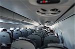 Interior airplane with passengers. Aircraft cabin after take off