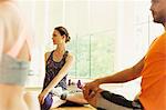 Fitness instructor leading class in twisting stretch